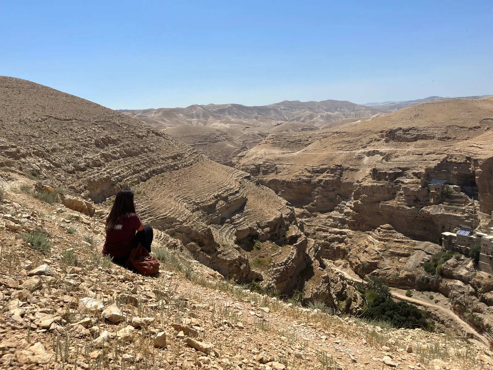 Mariana seated above the rocky landscape of the Judean Desert