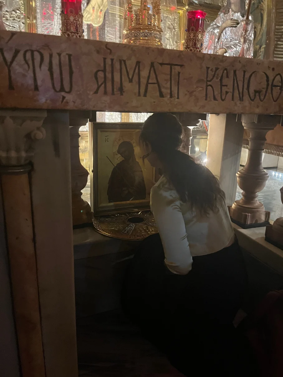 Mariana in prayer at the Church of the Holy Sepulchre